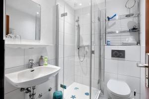 a bathroom with a shower and a sink and a toilet at Haus Anita in Menzenschwand +74 photos