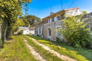 an old stone house with a dirt road at Maison de Vacances d'Amélie in Saint-Germain-dʼEsteuil
