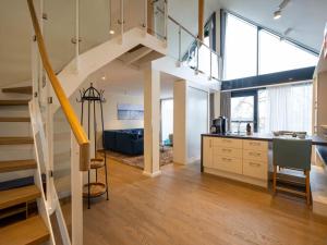 an open kitchen and living room with a staircase at Ferienwohnung Blau mit Müritzblick in Waren