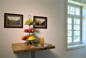 a table with three tiers of fruit on it at Ferienhaus Schäferhaus in Frielendorf