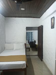 a bedroom with a bed and a living room at Sree Surya in Kallar Vattiyar