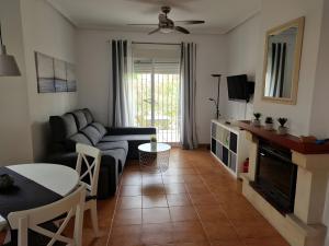 a living room with a couch and a table at Villa Capricho in Mazarrón