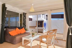 a living room with a couch and a table and chairs at Casa Conchita in Playa Honda