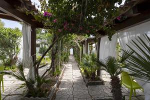 a walkway with plants and flowers in a building at 3 Sirene Sciacca Fronte Mare in Sciacca