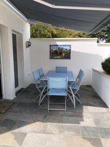 a blue table and chairs on a patio at Villa Sandra - Le Verdon, Medoc in Le Verdon-sur-Mer