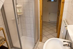 a bathroom with a shower and a sink at Gästehaus Neuwarft in Langeneß +48 photos