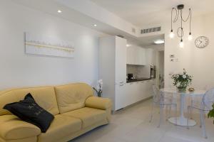 a living room with a couch and a table at Ricky's Luxury Apartment in Misano Adriatico
