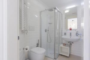 a bathroom with a shower and a toilet and a sink at Ricky's Luxury Apartment in Misano Adriatico +29 photos
