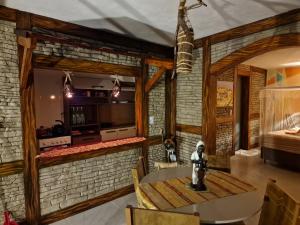 a room with a table and a brick wall at Castello Malu in Parajuru