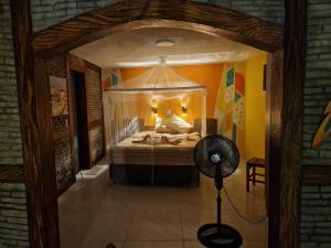a bedroom with a bed with a canopy at Castello Malu in Parajuru +19 photos