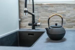a tea kettle sitting on a counter next to a sink at Ferienwohnung Rennbächle in Bad Wildbad