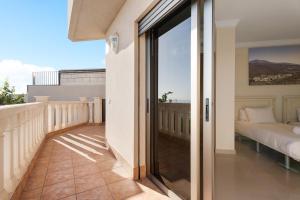 a balcony with a view of a bed at Villa Happy Holidays Pool Private in Puerto de Santiago +36 photos