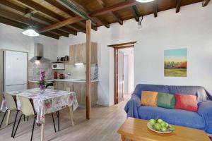 a living room with a blue couch and a table at Casa La Zahorra in Teno Alto