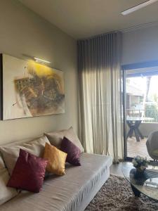 a living room with a couch and a glass table at Residence Alizees Spa in Mauritius