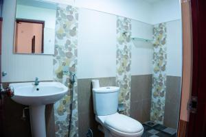 a small bathroom with a toilet and a sink at Green Edge Residences in Dambulla