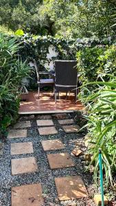 a bench and a chair sitting on a patio at The Urban Elm Guesthouse in Antwerp