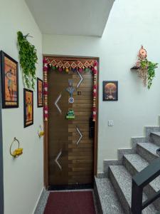 a front door with a christmas decoration on it at GURUGRAM CENTRAL NEAR To AIRPORT in Gumgaon
