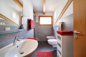 a bathroom with a sink and a toilet at Fröhlichhof Wohnung Panorama in Lagundo +30 photos