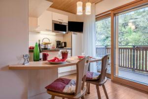 a kitchen and dining room with a table and chairs at Huberhof App Gala in Feldthurns