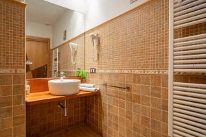 a bathroom with a sink and a mirror at L de Alborada del Eo in Villameitide +32 photos