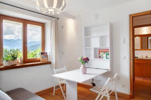 a white dining room with a table and chairs at Bergnest Penning in Hopfgarten im Brixental +15 photos