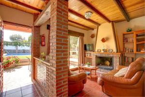 a living room with couches and a brick fireplace at Casa Buganvilla by Vintage Travel in Órgiva