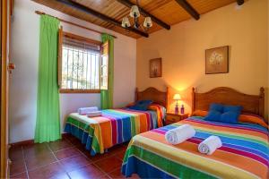 a bedroom with two beds in a room at Casa Buganvilla by Vintage Travel in Órgiva +22 photos