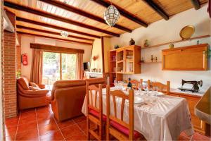 a dining room with a table and a living room at Casa Buganvilla by Vintage Travel in Órgiva