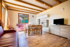 a living room with a table and a tv at Casa Damiano in Tremosine Sul Garda