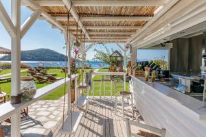 an outdoor bar with a view of the ocean at Milia Beach Apartments in Paralia Milia