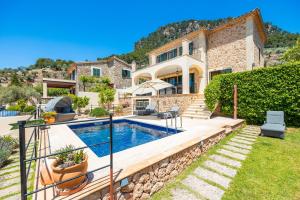a villa with a swimming pool and a house at Sa Papaiona in Valldemossa
