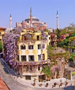 a garden scene with flowers and a clock tower at Hotel Empress Zoe in Istanbul