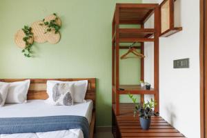 a bedroom with two beds and a wooden ladder at The Garden Retreat by StayJadePool2BHKLawn in Berikai +32 photos