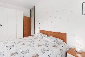 - une chambre dotée d'un lit avec des papillons dans l'établissement Appartamento Aurora - Verbania, à Verbania