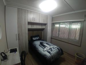 a bedroom with a king sized bed and a window at 220 Mclarty in Durban