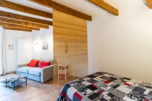 a bedroom with a bed and a couch at Chambre Coquelicot in Auriac-du-Périgord