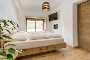 a bedroom with a bed and a window at Labe Biohof Oberzonn in Kastelruth +24 photos