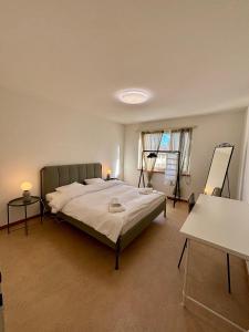 a bedroom with a bed and two tables and a window at Köschenrütistrasse 59, 8052 Zürich, Switzerland in Zürich