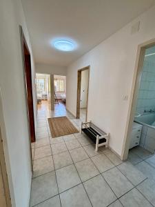 a living room with a tile floor and a room with a sink at Köschenrütistrasse 59, 8052 Zürich, Switzerland in Zürich