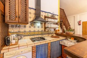 a kitchen with a sink and a stove top oven at Casa rural a pie de Sierra Nigüelas in Nigüelas