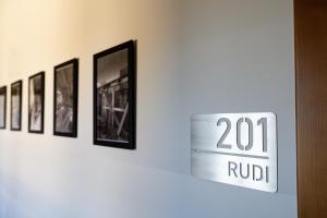 a sign on a door with pictures on a wall at Apartamenty Nad Drwęcą in Brodnica