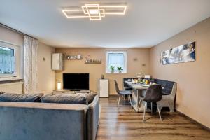 a living room with a couch and a table at Brunnerhof Urlaub auf dem Land in Hartenstein