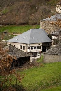 an old stone house with a gray roof on a hill at Casa Luna de La Viliella in La Viliella