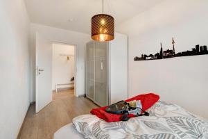a bedroom with a bed and a chandelier at Ferienwohnung Griaß di in Salgen