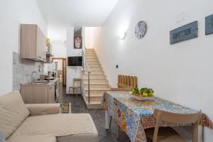 a kitchen and a living room with a table and chairs at Casa Giorgia in Avola