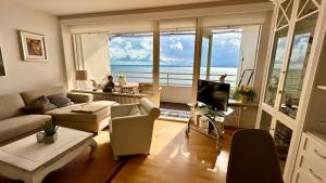 a living room with a view of the ocean at Apartment am Meer in Sierksdorf