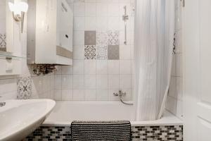 a white bathroom with a tub and a sink at Ferienhaus Pfanne in Hennstedt +18 photos