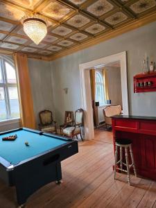 a living room with a pool table and a table at Solvang in Assens