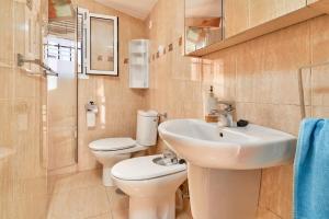 a bathroom with a sink and a toilet and a shower at Casa Ian in Frigiliana +16 photos