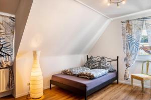 a bedroom with a bed with pillows and a vase at Ferienhaus Barockhaus Fulda in Petersberg